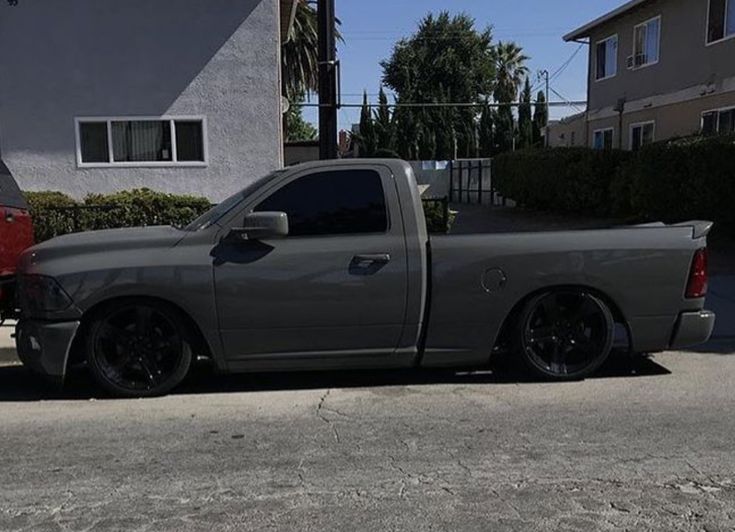 a gray truck parked in front of a house