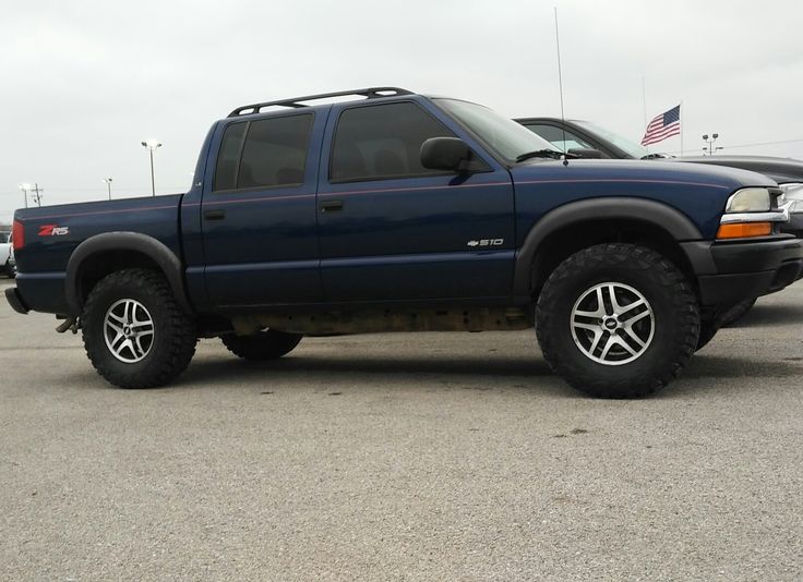 a blue pick up truck parked in a parking lot