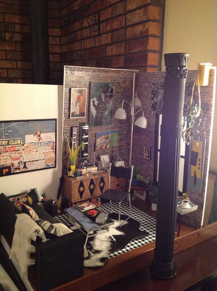 a living room filled with furniture next to a brick wall