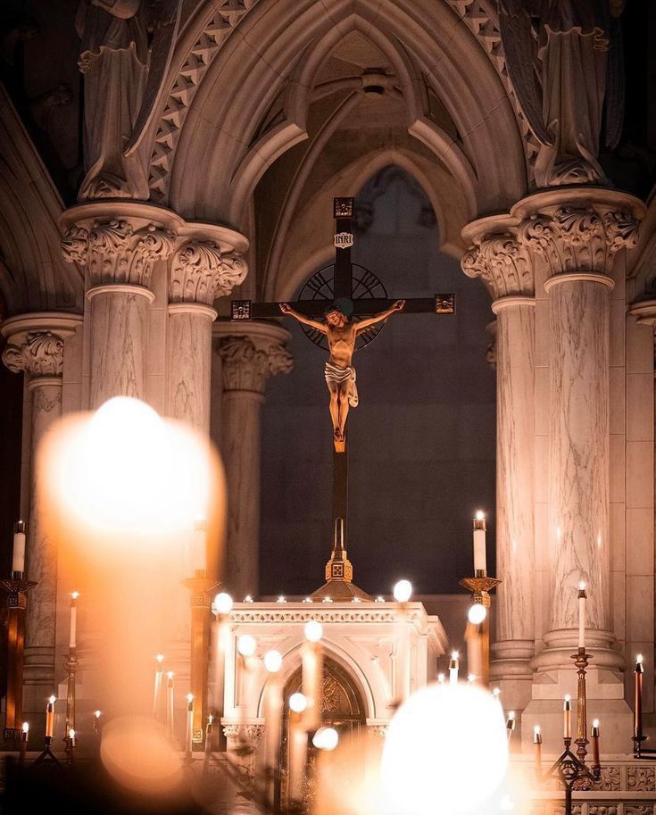 the crucifix is on display in front of candles