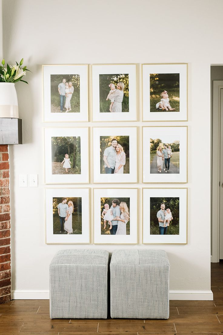 the family photos are hanging on the wall in the living room, and there is also a footstool