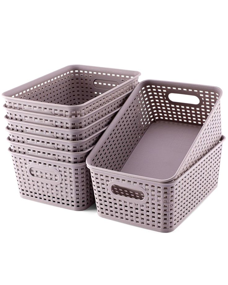 four plastic baskets are stacked on top of each other, one is grey and the other is white