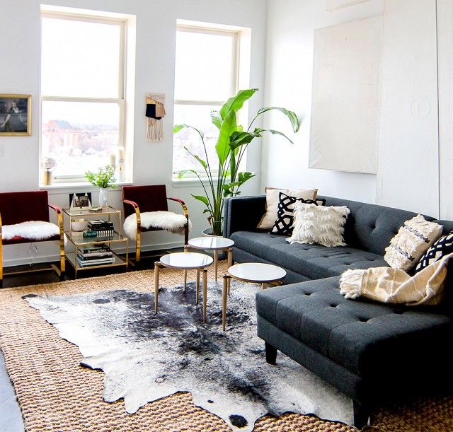 a living room with two couches and a rug in front of the window,