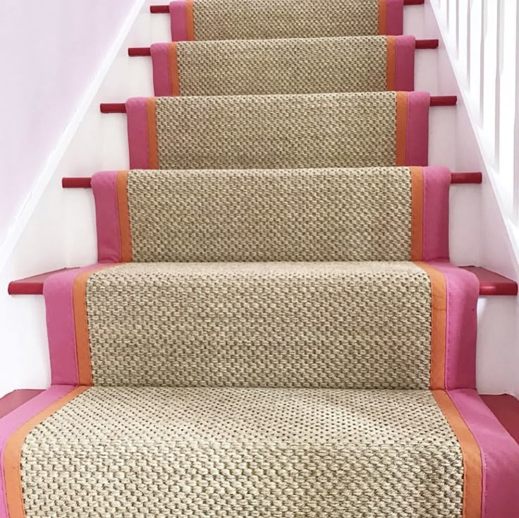 a set of stairs with pink and orange carpet