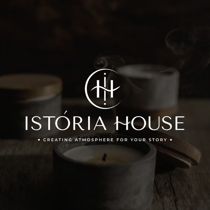 the logo for isttoria house is shown on top of a wooden table with two candles