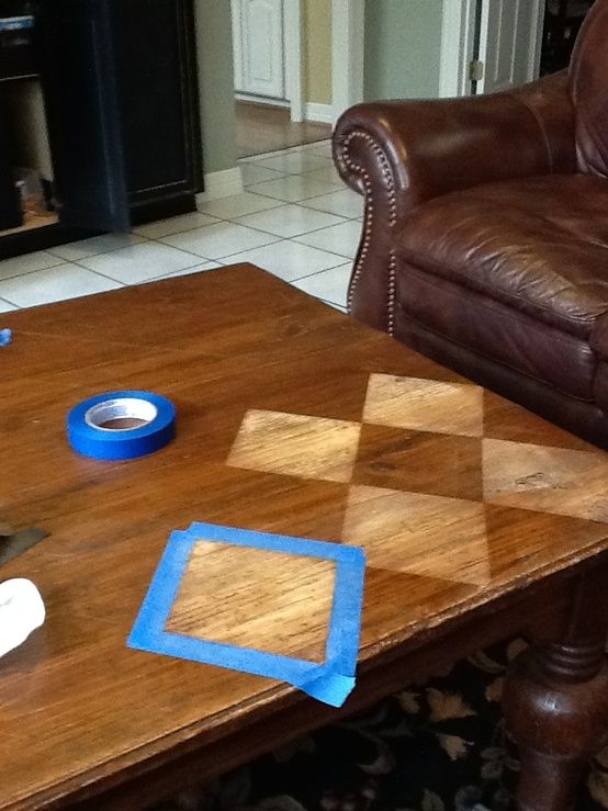 a table that has some tape on it and a couch in the background with other items