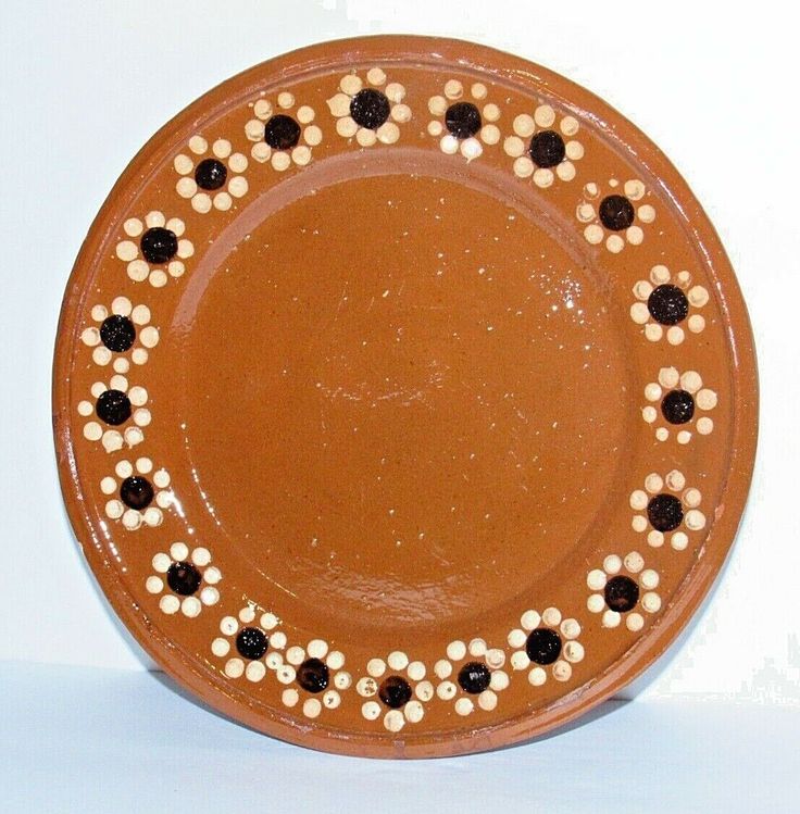 a brown plate with black and white flowers on it