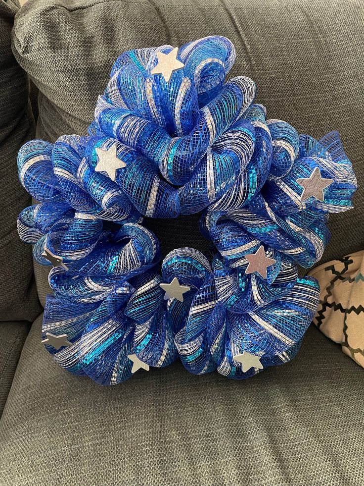 a blue and white wreath sitting on top of a couch