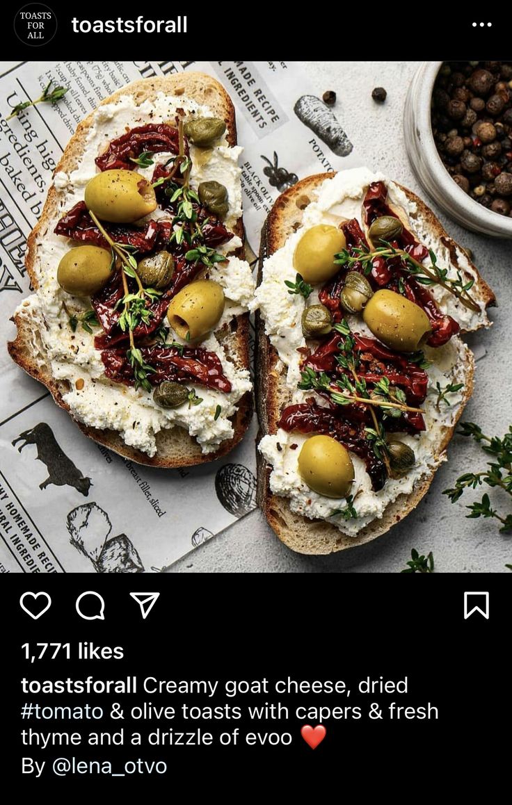 two pieces of bread topped with olives and goat cheese