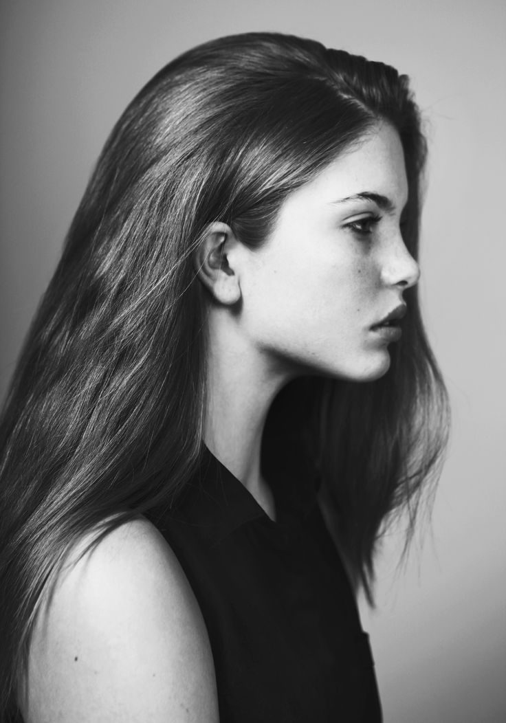 a black and white photo of a woman's head with long, straight hair