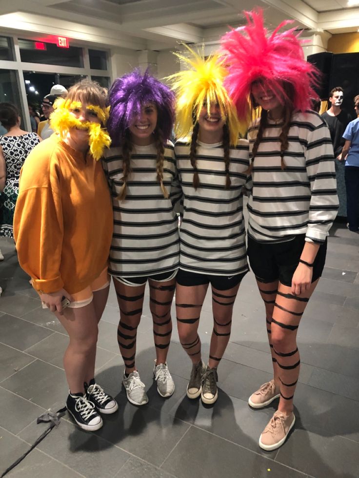 three women dressed in costumes posing for the camera