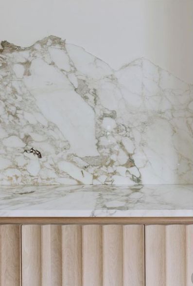 a white marble counter top sitting next to a radiator