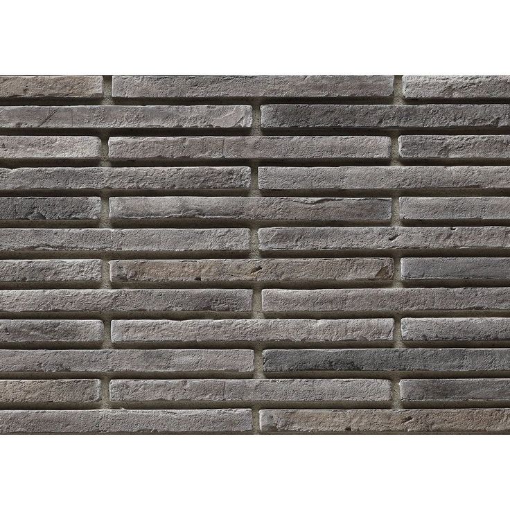 a brick wall made out of grey bricks