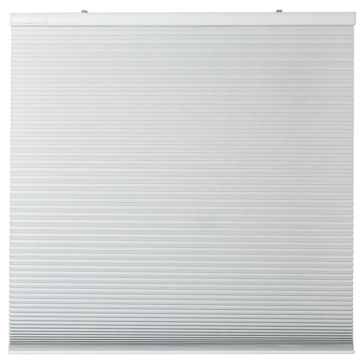 a white roller shade on the side of a window