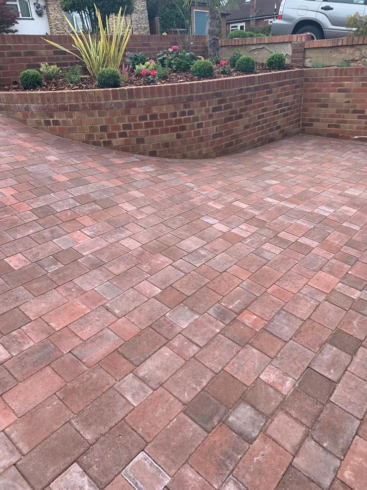 a brick patio in front of a house