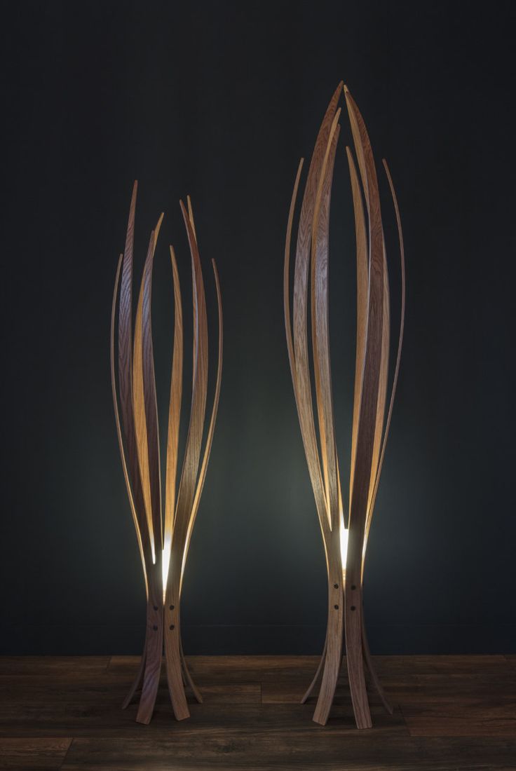 two wooden sculptures with lights on them