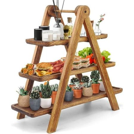 a three tiered wooden shelf filled with food and plants on top of each other