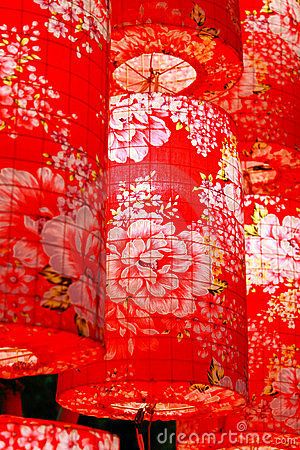 many red lanterns with white flowers on them