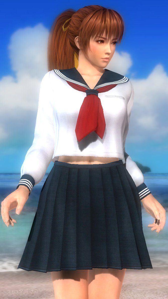 a girl in a sailor outfit standing on the beach with her hands behind her back