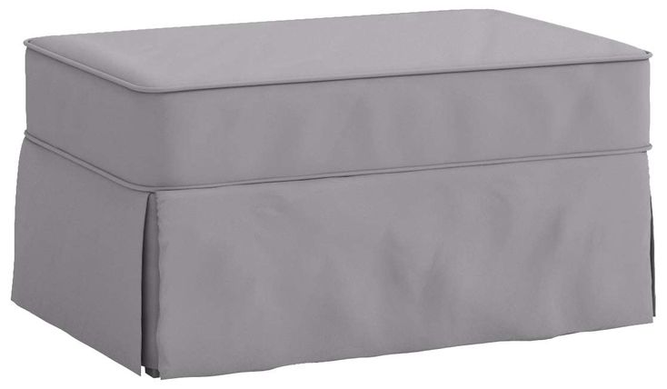 a grey ottoman with a cover on it