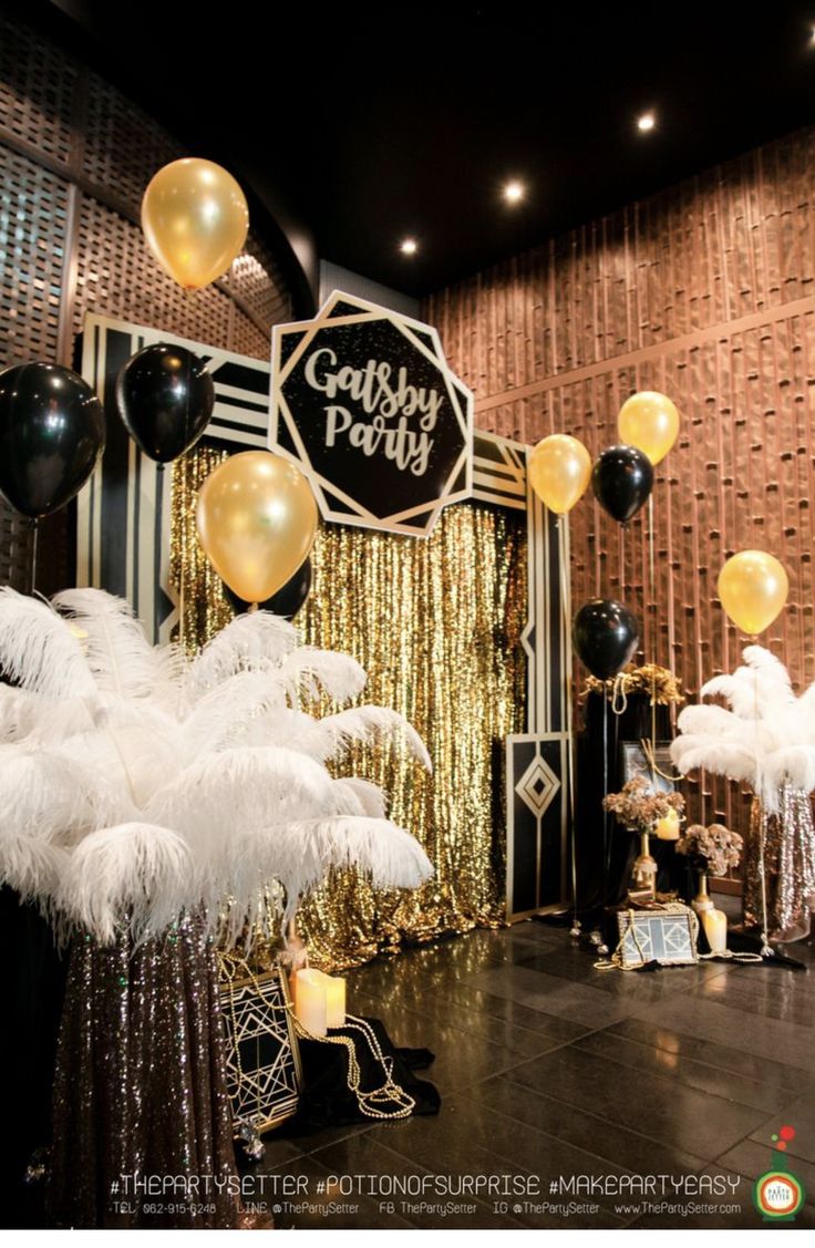 an image of a party with balloons and feathers on the floor in front of it