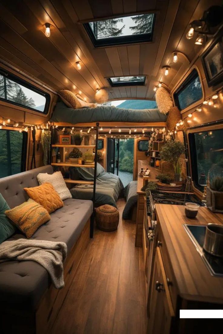 a living area with couches, windows and lights on the ceiling is lit up by string lights