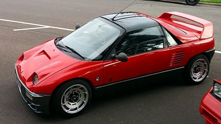 a red sports car is parked on the street