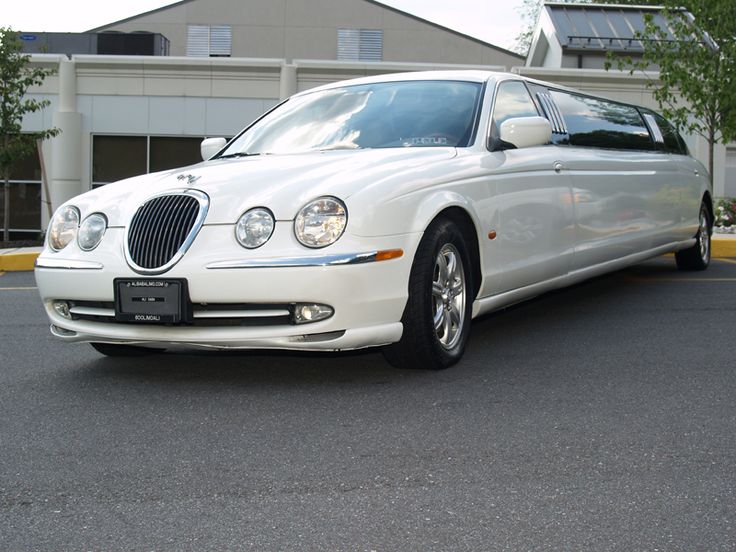 a white car parked in front of a building