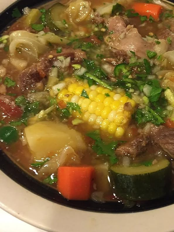 a white bowl filled with soup and vegetables