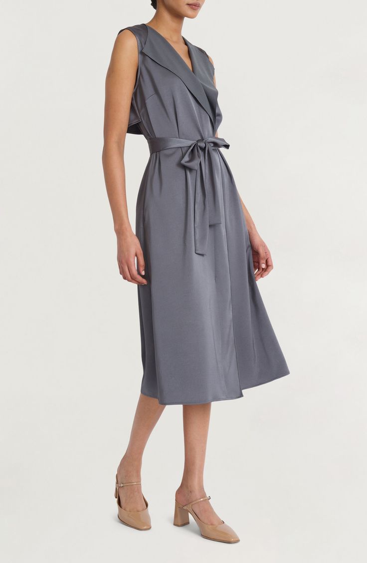 Satin accents lend casual elegance to a modern take on the classic shirtdress silhouette. 47" length (size Medium) True wrap style Surplice V-neck; shawl collar Sleeveless Unlined 100% polyester Machine wash, dry flat Imported Classic Shirt Dress, Sleeveless Shirt Dress, The Cove, Back Stretches, Illusion Dress, Maggy London, Stretch Satin, Shirtdress, Casual Elegance