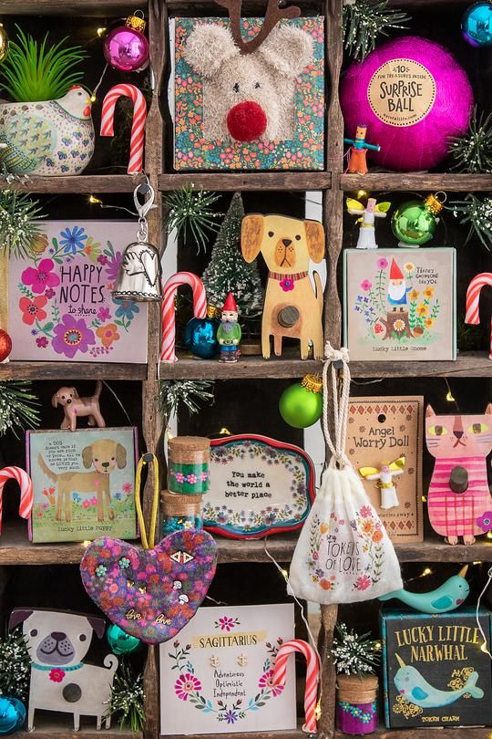 a wooden box filled with lots of christmas decorations and cards on top of a table