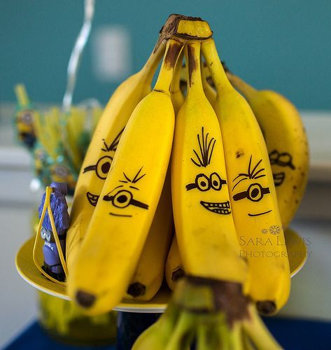 bunches of bananas with faces drawn on them