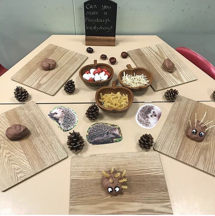 a table topped with plates and bowls filled with different types of food next to pine cones