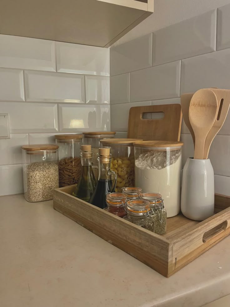 the kitchen counter is organized with spices and condiments, including salt and pepper shakers