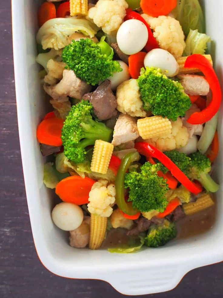 a casserole dish with broccoli, cauliflower and carrots