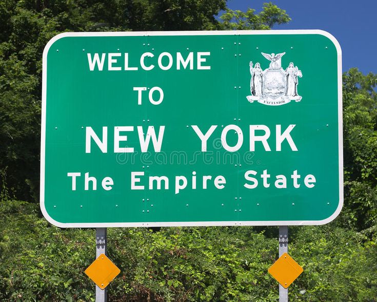 a welcome sign to new york the empire state is green and white with black lettering