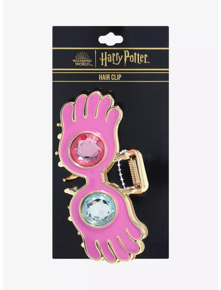 a harry potter hair clip with a pink bird on it