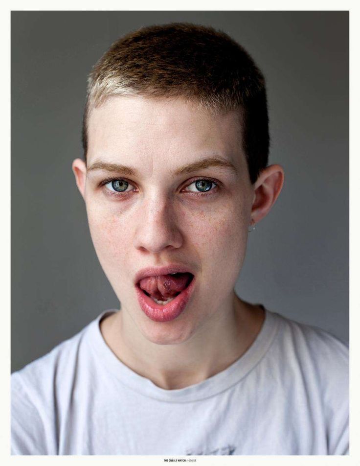 a young boy making a funny face with his tongue out