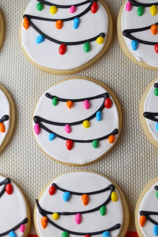 decorated cookies are arranged on a baking sheet