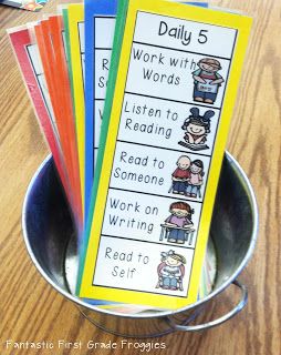 a bucket filled with different types of words and pictures on top of a wooden table