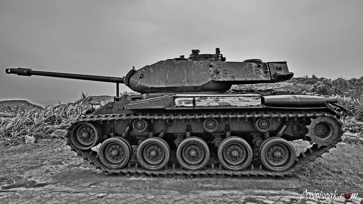 an old tank sitting on top of a dirt field