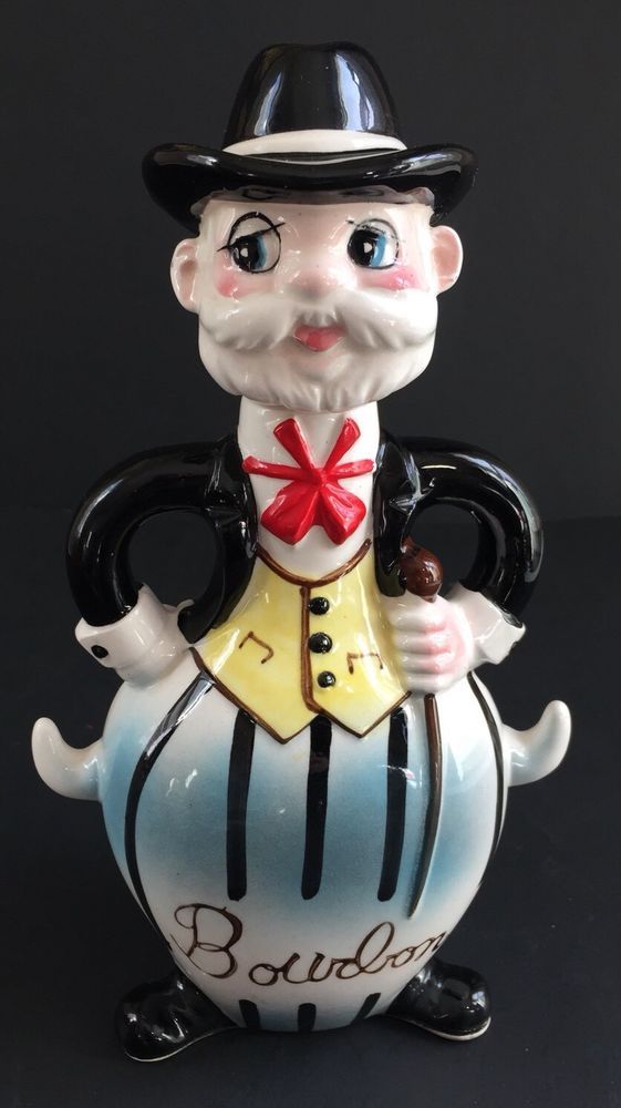 a glass figurine with a top hat and bow tie