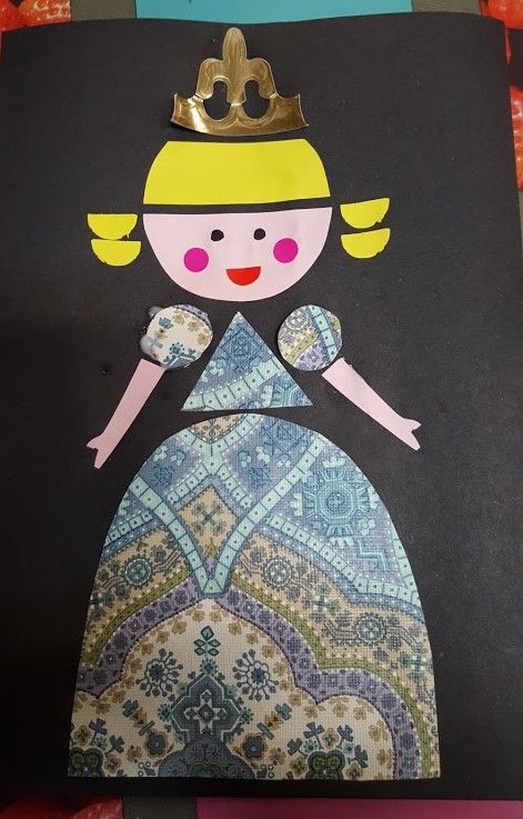 a paper doll with a crown on top of it