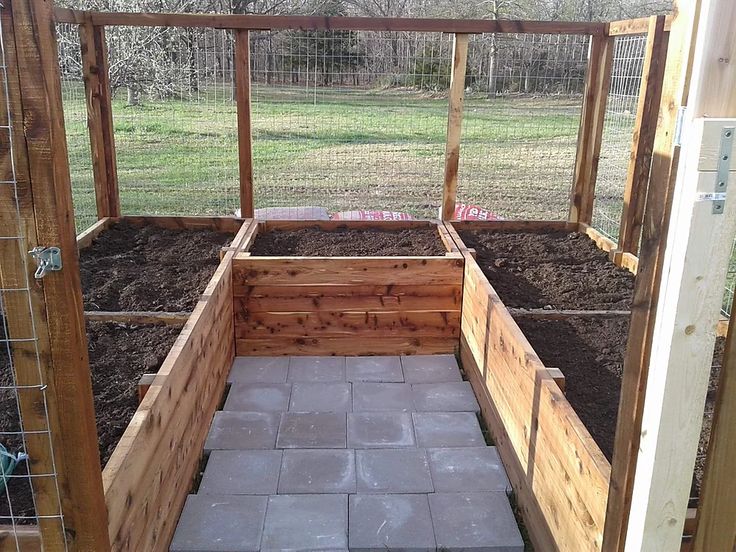 an outdoor garden area with stone walkway and raised planter