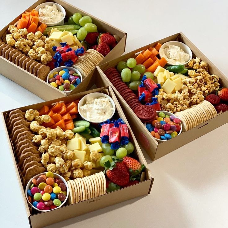 two boxes filled with different types of snacks