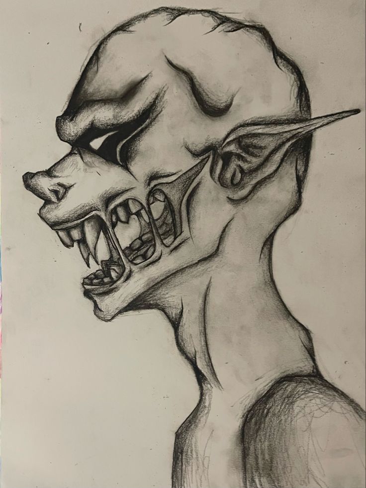 a drawing of a man's head with teeth and fangs on his face is shown