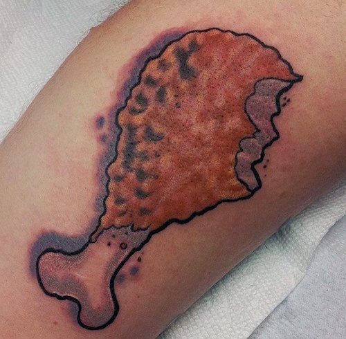 a close up of a person's arm with a tattoo on it that looks like a piece of bread