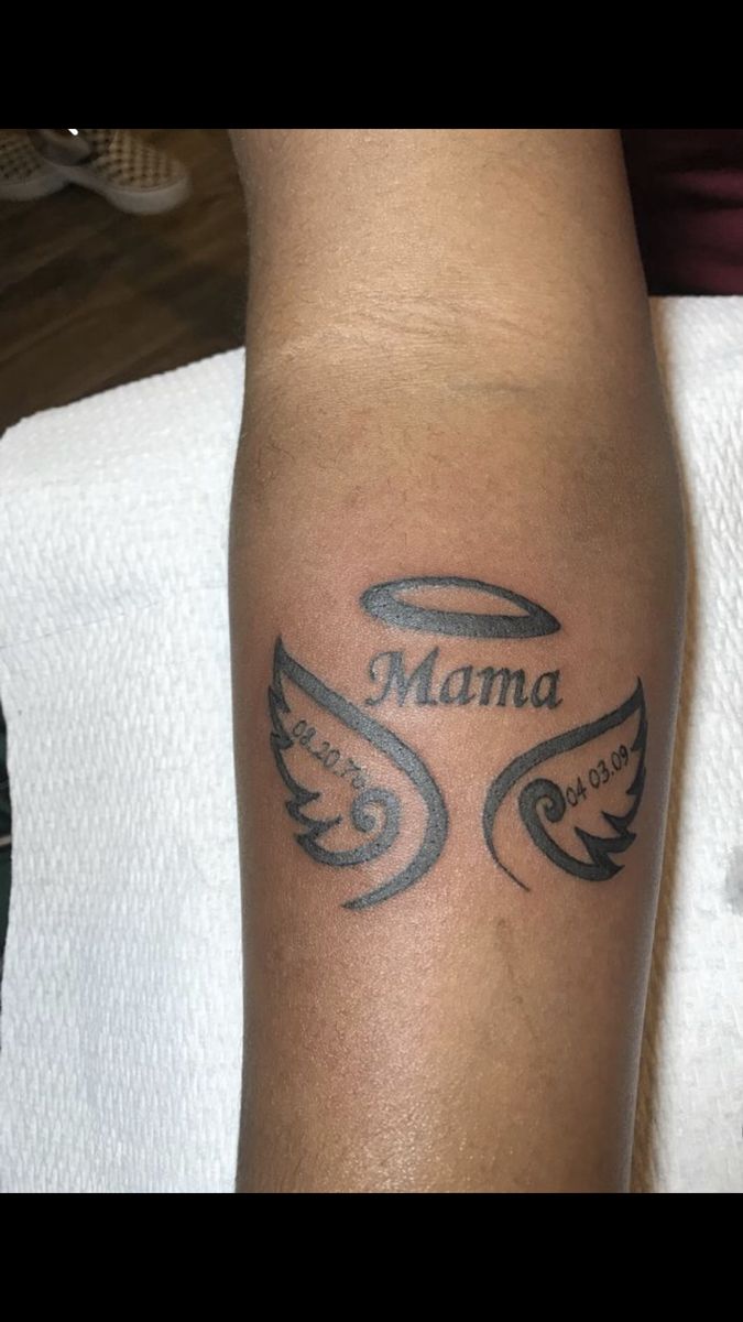 a man with a tattoo on his arm that reads mama and has wings around it