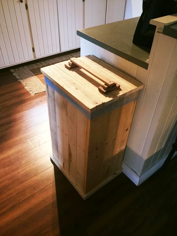 a kitchen with wooden floors and white cabinets