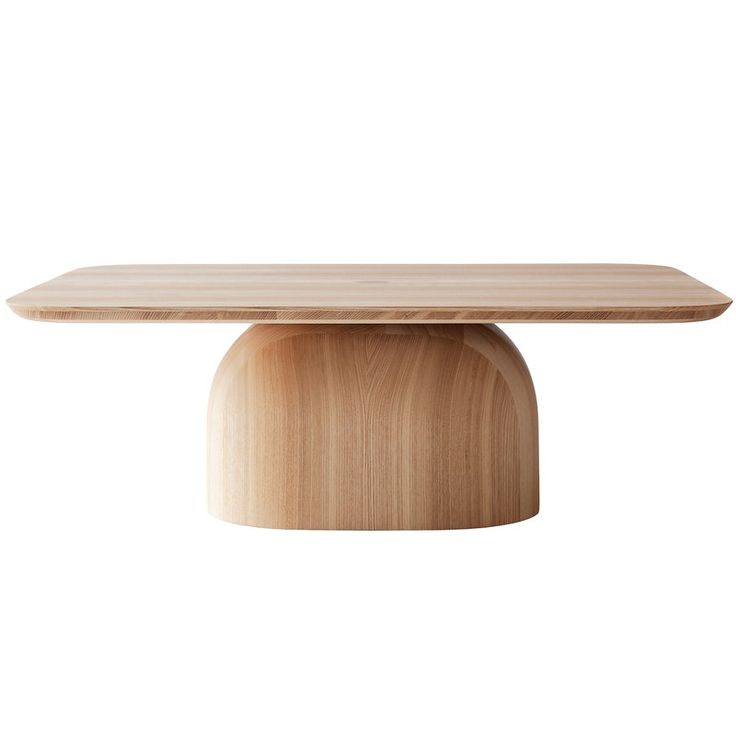 an oval wooden table with a white surface and light brown wood grain on the top